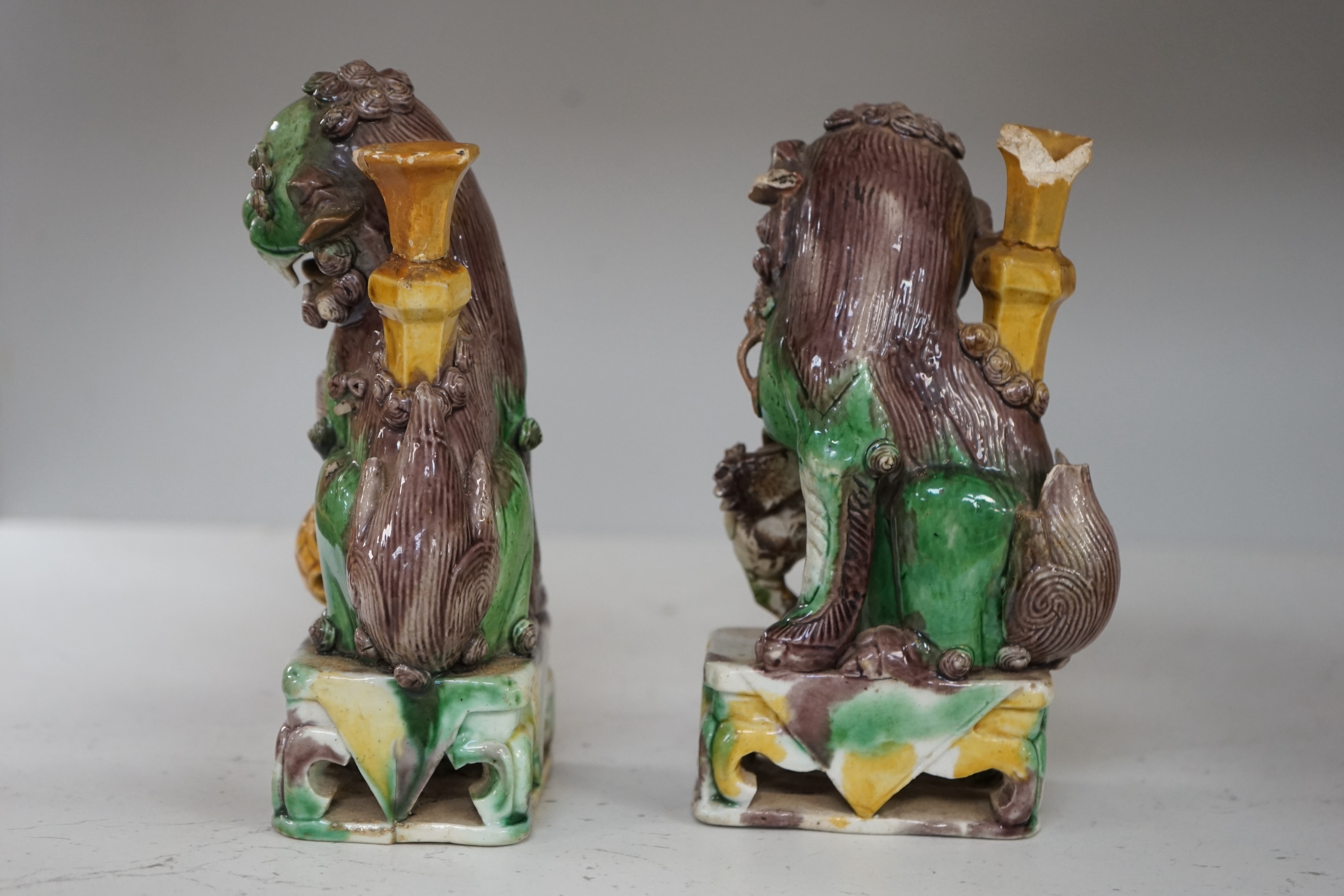 A pair of Chinese Sancai glazed lion joss stick holders, 18th century, 17cm high. Condition - some restoration